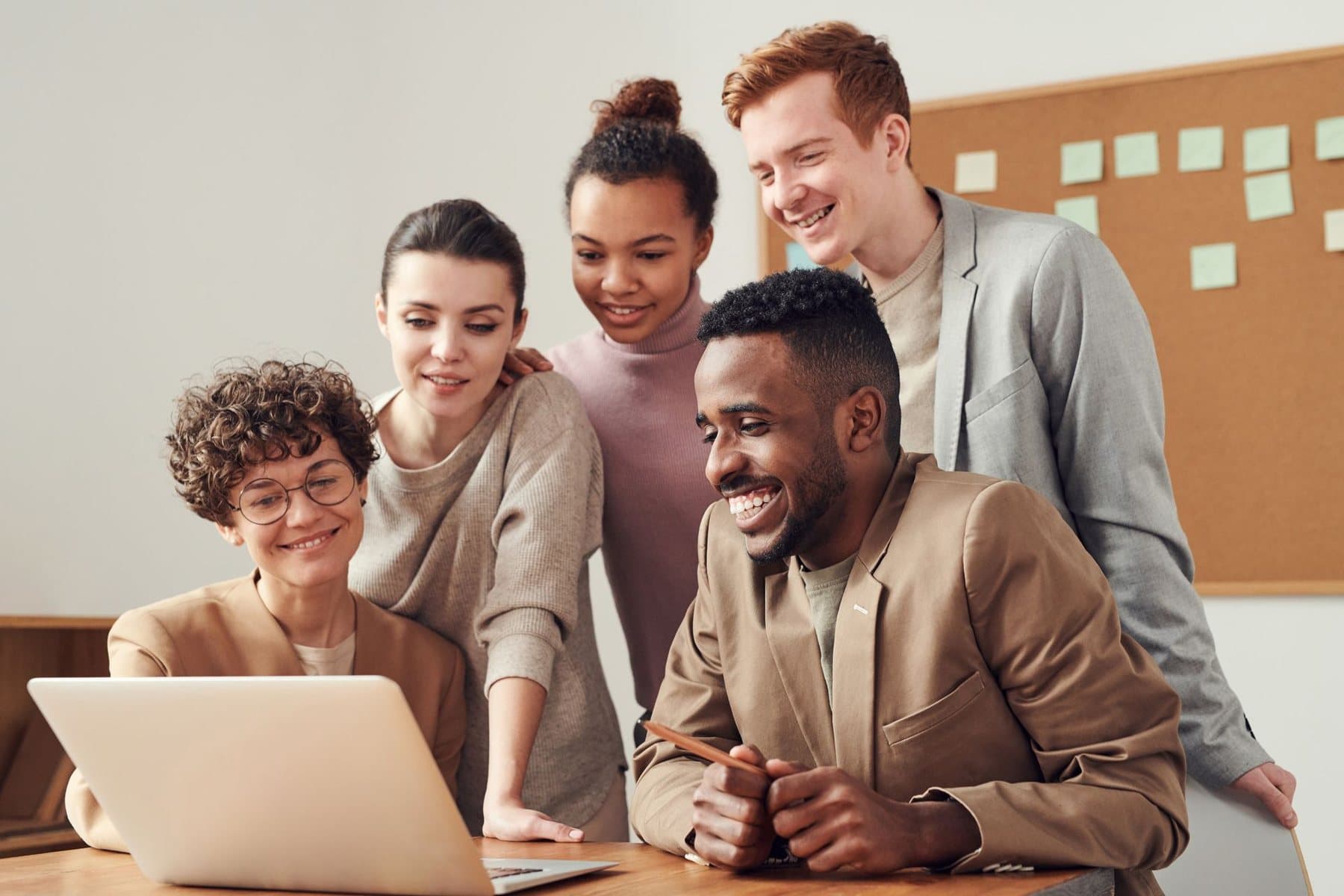 A team working together around a laptop